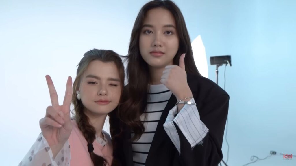 GL actress duo with serious expressions, evoking the darker side of GL Fandom Drama.