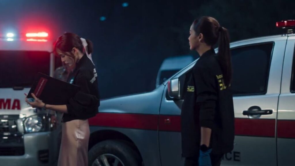 Tul and Cherran at a crime scene in Petrichor, a standout GL series with crime and emotional depth.
