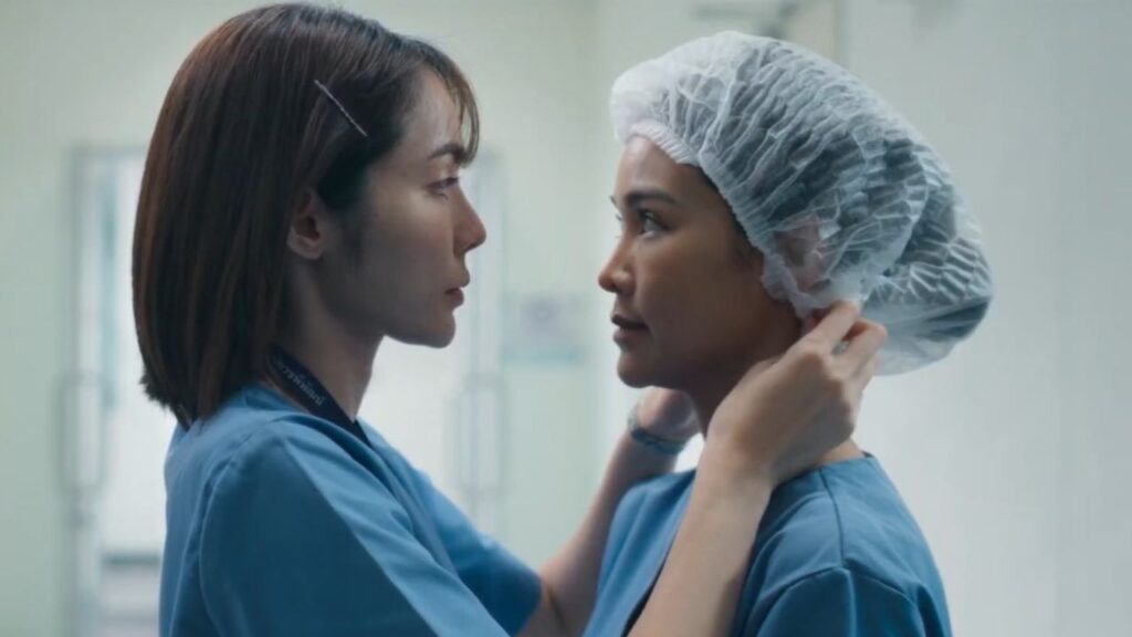 Intimate forensic scene from Petrichor featuring Tul and Cherran, blending mystery and romance in a crime-focused GL drama.