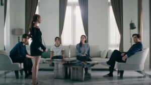 Family scene from US showing Dokrak, Kawi, and Nene, highlighting the tension and generational pressure within the household.